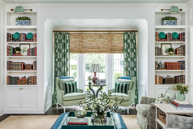 traditional-living-room-with-floral-accent-chairs-and-tall-bookshelves