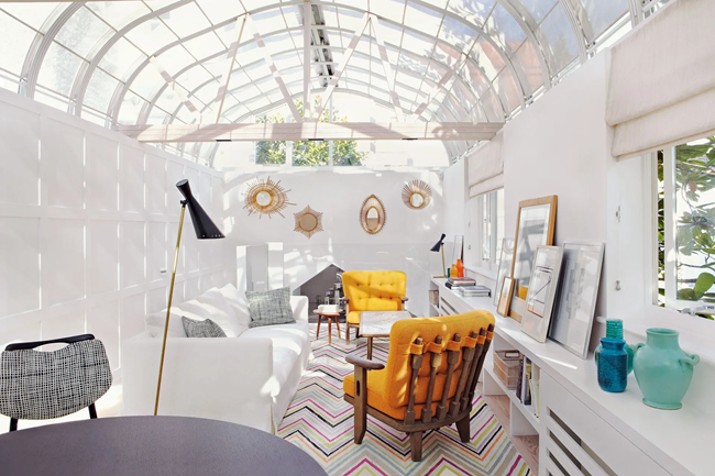 all-white-long-living-room-layout-with-white-couch-and-two-accent-yellow-armchairs