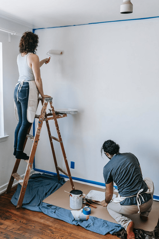 woman-painting-an-interior-wall-to-for-a-bedroom-refresh