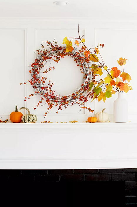 Fireplace-mantel-with-fall-decor-wreath-and-orange-leaves