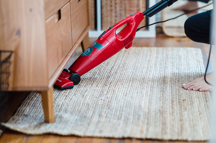 woman-vacuuming-rug-to-eliminate-bad-order