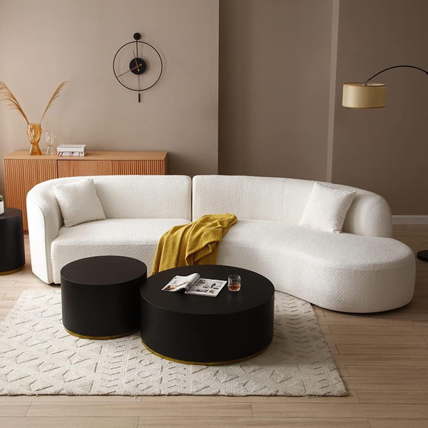 Modern-living-room-with-dark-brown-walls-with-modern-white-curved-couch-and-round-nested-coffee-tables-best-couches-to-consider