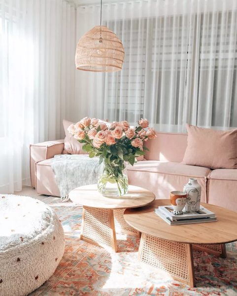 feminine-living-room-with-a-soft-pink-couch-and-nesting-tables