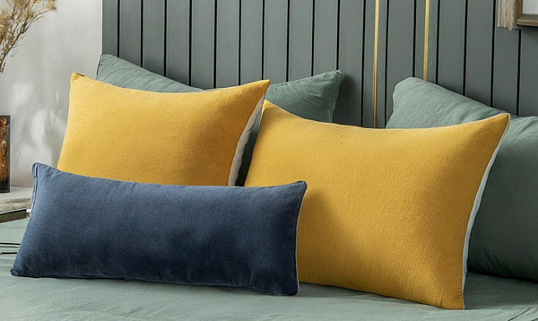 a-pair-of-throw-pillows-with-lumber-on-front-in-a-modern-bed