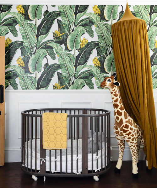 a-nursery-with-a-rain-forest-wallpaper-and-giraffe