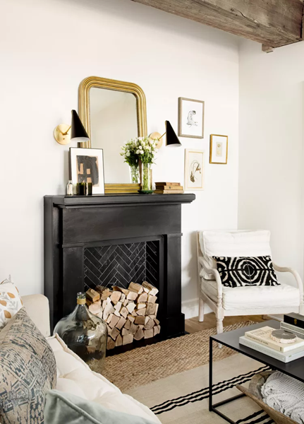 Fireplace-in-a-modern-living-room-in-a-black-matt-finish-with-personal-decor-touches-to-add-charm