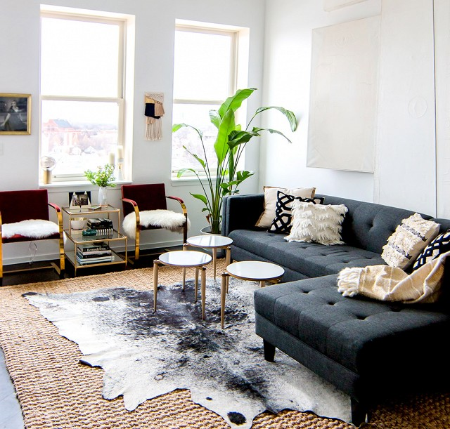 a-boho-living-room-with-grey-cowhide-and-orage-armch-chairs