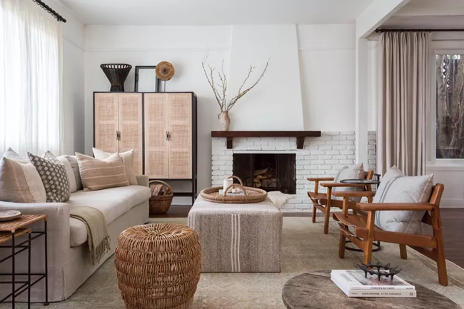earthy-living-room-with-modern-brown-leather-arm-chairs-and-rattan-tall-cabinet