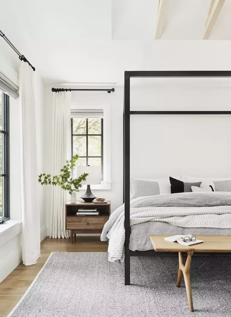 all-white-feng-shui-bedroom-with-bed-positioned-diagonally-from-the-door-with-lots-of-natural-lighting-and-large-windows